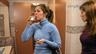 Woman drinking mouthwash in restroom