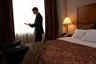 Man completeing expense report in hotel room
